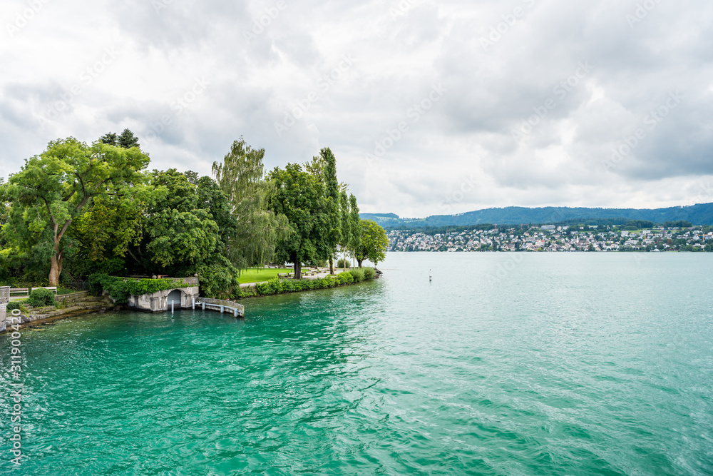 Beautiful lake Zurich landscape. Cloudy skyscape with  background of Alps mountains peaks.