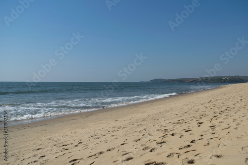 Keri beach, North Goa, India. Sandy coast and blue sky
