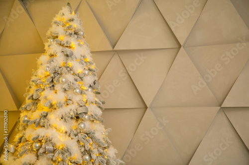 Gold Christmas tree with a gift in the living room photo