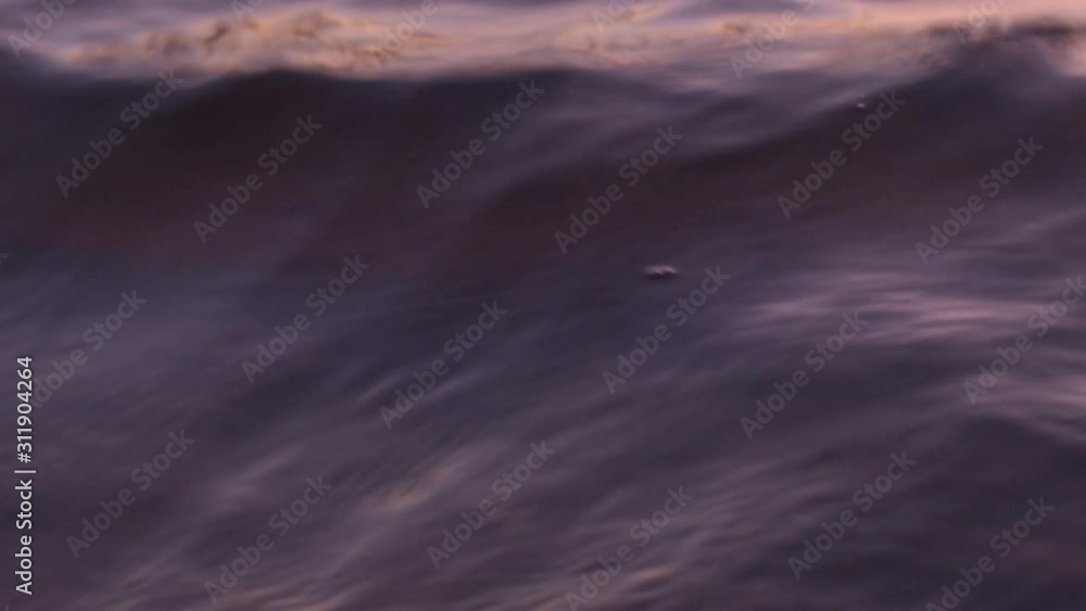 Close-up of the surface of the water in the river at sunset in the fall. Recorded in Raw on Blackmagic camera. Close-up of the surface of the water in the river at sunset in the fall. Recorded in Raw on Blackmagic camera.