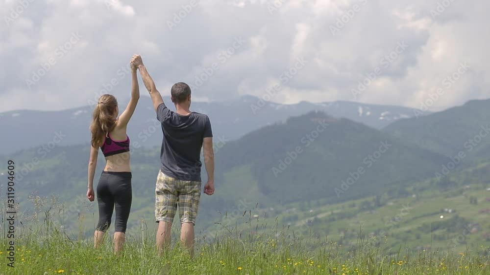Young couple man and woman jogging outdoors in summer mountains. Young couple man and woman jogging outdoors in summer mountains.