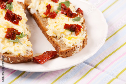 Delicious fresh scrambled eggs and dried tomatoes sandwich