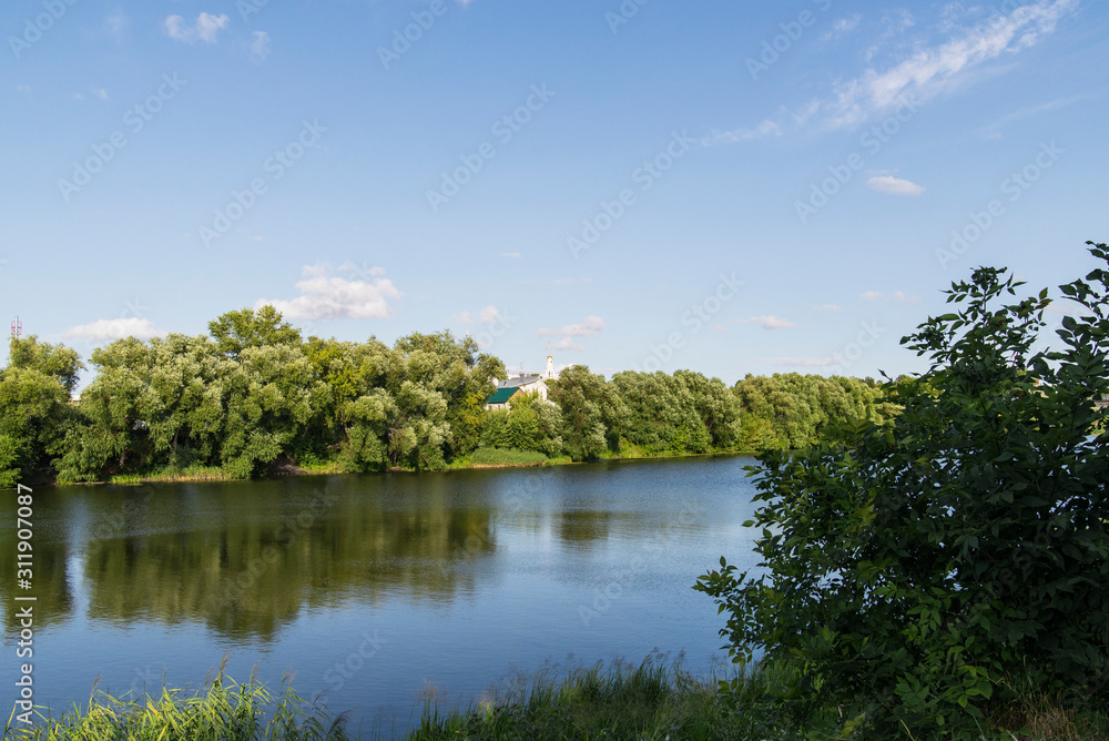 Bank of the Oka River, green spaces and the church in the background