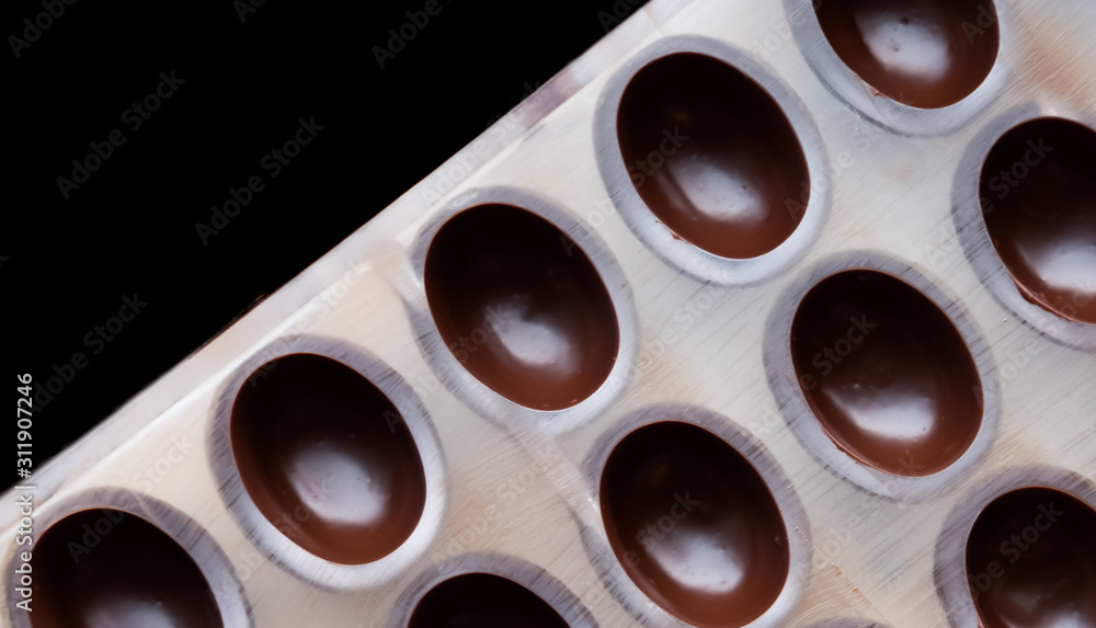 Dark chocolate pralines in mold. Dark chocolate pralines in mold.
