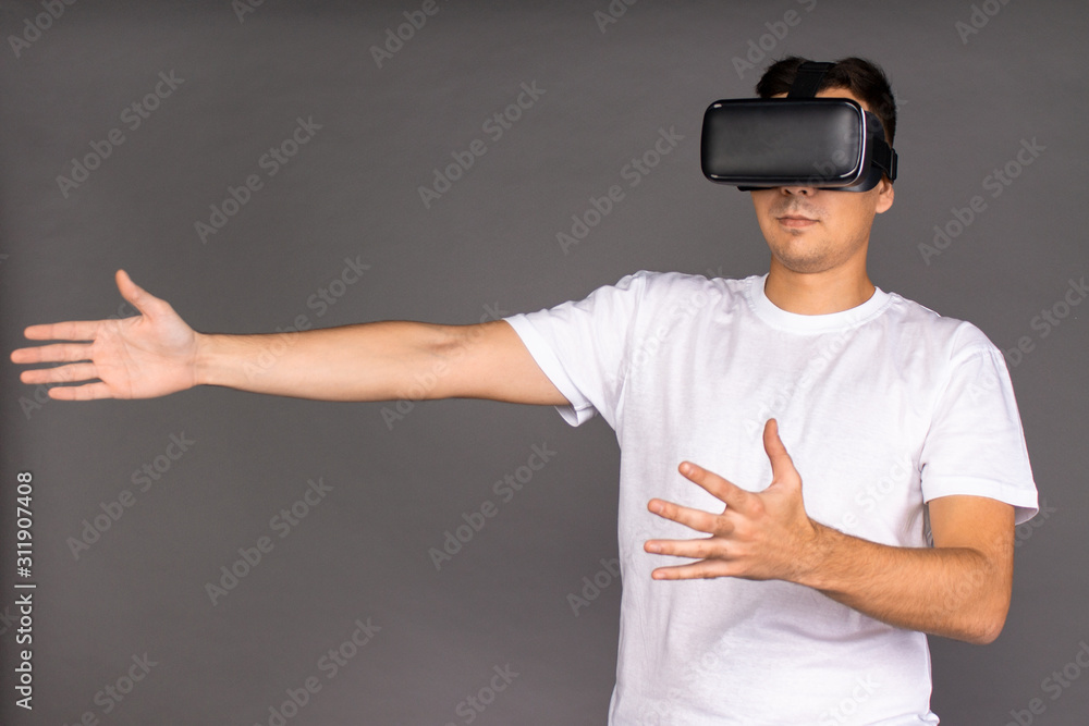 A guy in virtual reality glasses is studying his surroundings. Future and modern technologies A guy in virtual reality glasses is studying his surroundings. Future and modern technologies