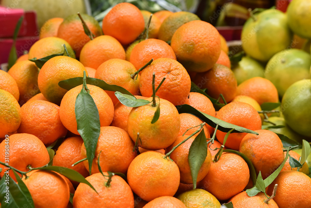 A bunch of fresh tangerines. Citrus fruits on the market. A bunch of fresh tangerines. Citrus fruits on the market.