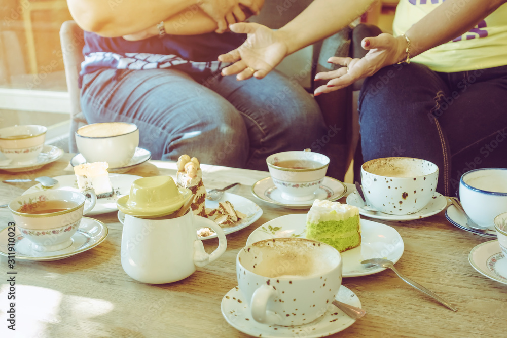 Fotka „Happiness female friends meeting and drinking tea or coffee with  cakes together at cafe in the afternoon. People, leisure and communication  concept. Selective focus.“ ze služby Stock | Adobe Stock