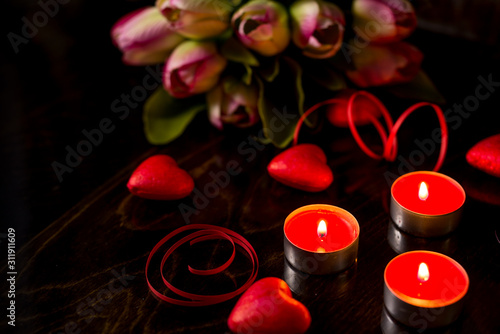Valentine's day romantic background with hearts and candles. holiday background with hearts. Celebrating weddings and other celebrations with space for text.