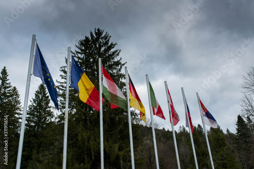 Waving european flags in local World War 1 and 2 memorial park in Transylvania, Romania. photo