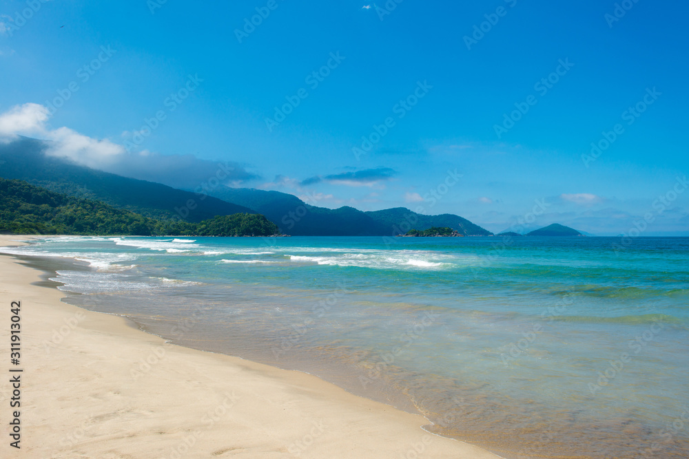Beautiful beach with mountains on background.