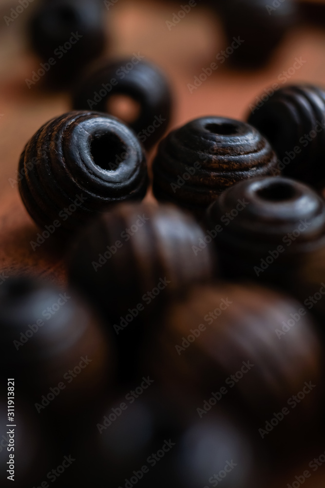 brown beads on a wooden tray and a white table brown beads on a wooden tray and a white table