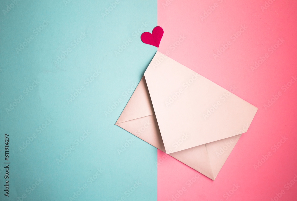 white postal envelope on a pink and blue background, with paper hearts, heart in the form of paper, layout for Valentine's day white postal envelope on a pink and blue background, with paper hearts, heart in the form of paper, layout for Valentine's day