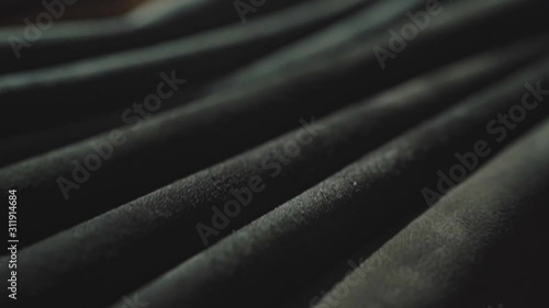 Rolls of leather in different colors on the table. Soft daylight falling on it. Closeup shot. 