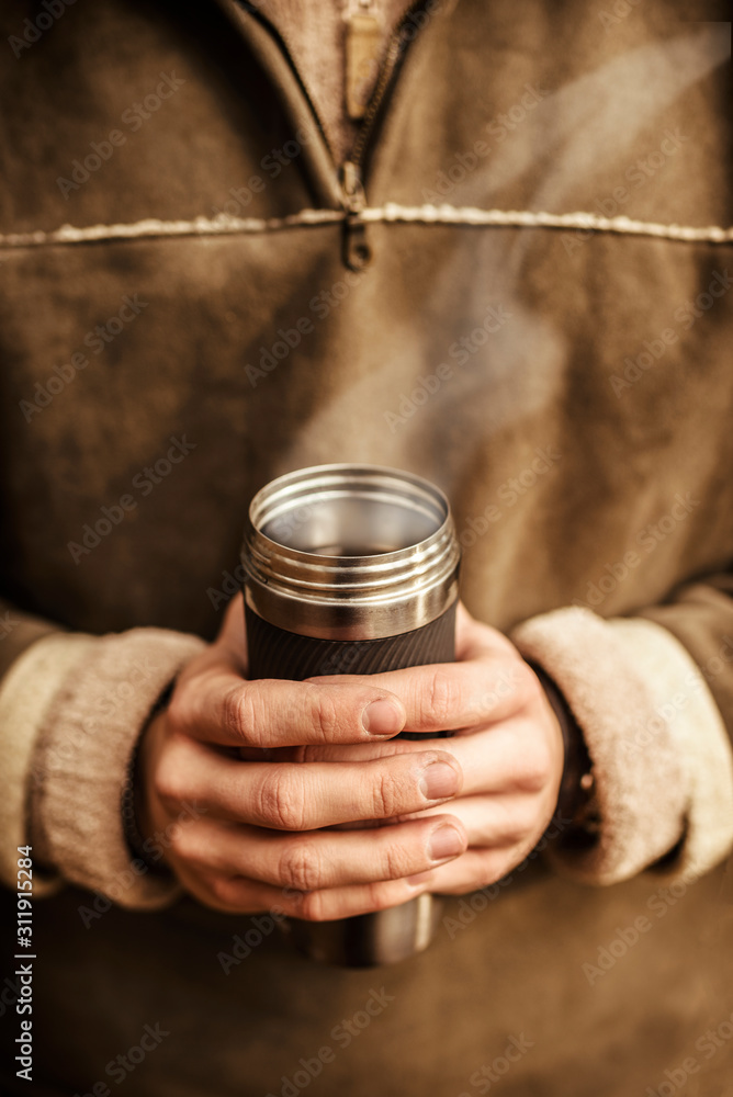 Cup of hot drink is holding by hands Cup of hot drink is holding by hands