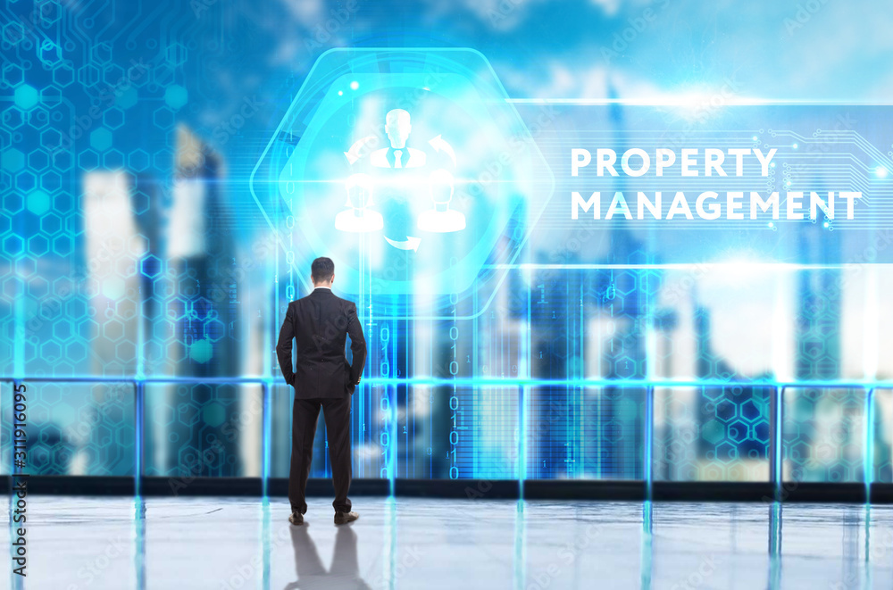 Business, Technology, Internet and network concept. Young businessman working on a virtual screen of the future and sees the inscription: Property management Business, Technology, Internet and network concept. Young businessman working on a virtual screen of the future and sees the inscription: Property management