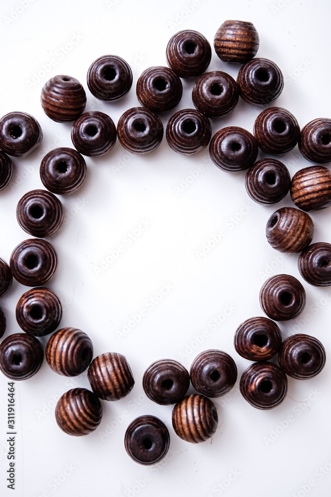 brown beads on a white table with circle copy space brown beads on a white table with circle copy space