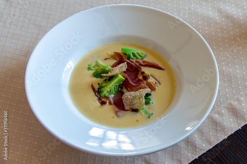 Cream soup with cheese, broccoli and proshuto