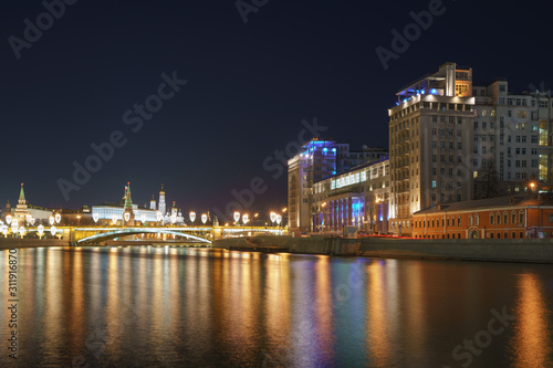 Photography of Moscow cityscape in winter night. Modern duildings, Kremlin wall and Towers, Residence of the President of the Russian Federation, Ivan the Great Belltower. Long exposure image. 