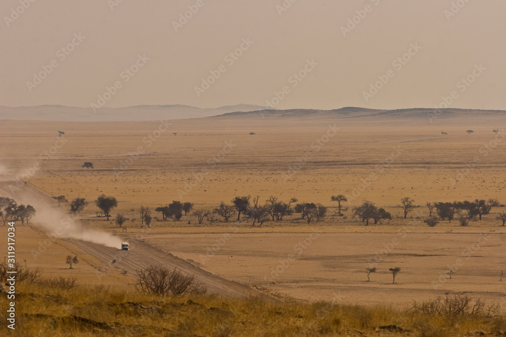 Vehicle traveling through Namibian unpaved roads