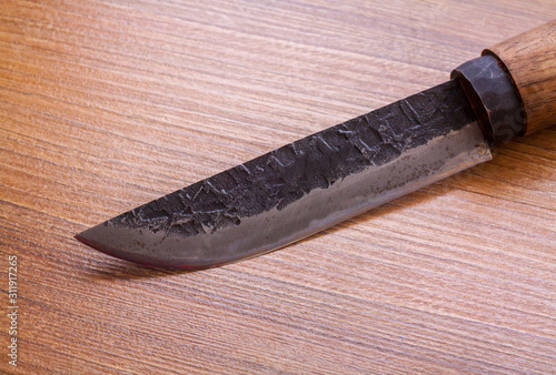 Japanese traditional Tosa Hunting Knife on wood background