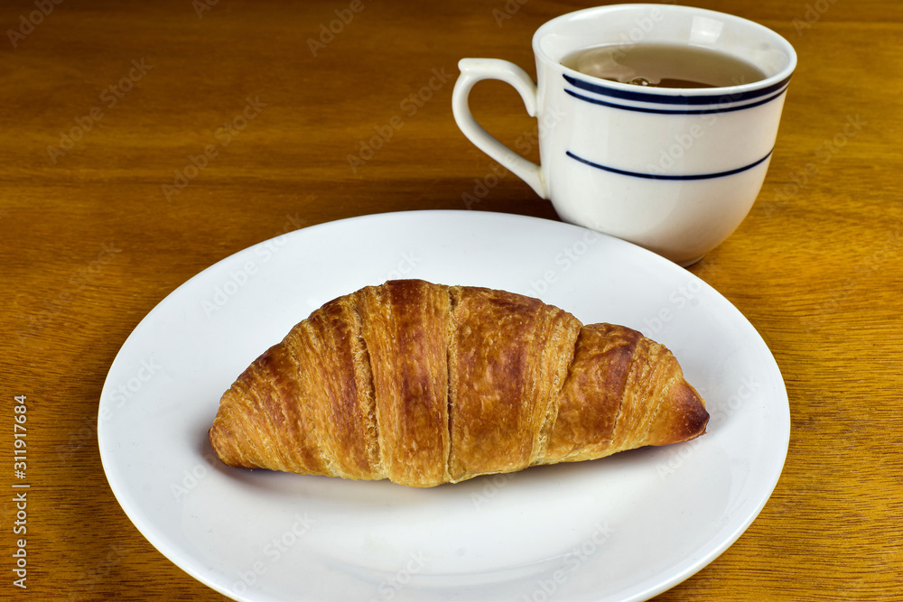 mini croissant with a cup of tea