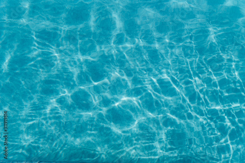 Beautiful refreshing blue swimming pool water. Background of blue water in the pool