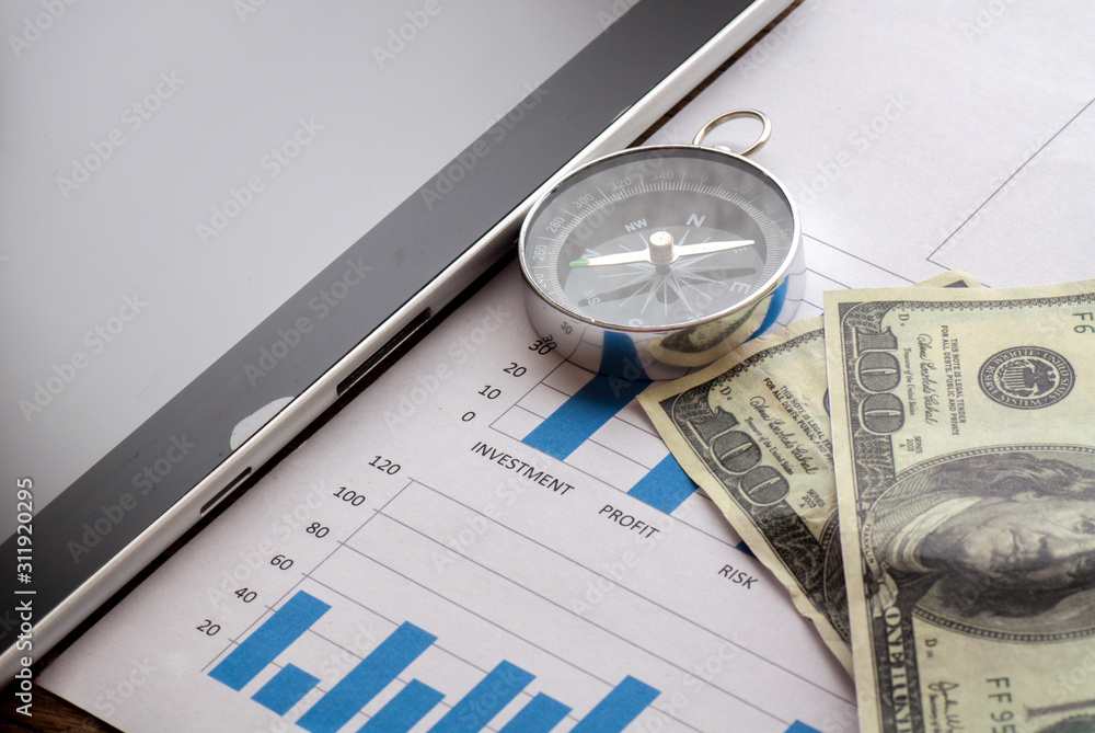 Business concept,graph with compass,money and tablet Business concept,graph with compass,money and tablet