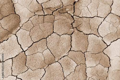 Cracked surface near the salt mountains in Soligorsk city in Belarus. Earth in the cracks. Light beige background. Close-up. The symbol of love.