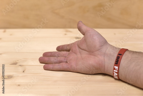 Hand on Wooden Table