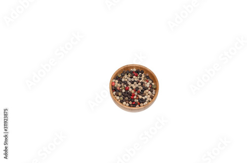 Mixture of peppers hot, red, black, white and green pepper seasoning in a wooden bowl, top view isolated on wite background