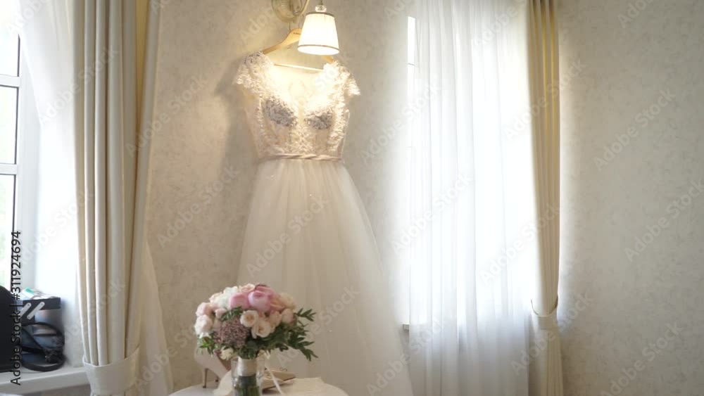wedding dress hanging on the bride's fees wedding dress hanging on the bride's fees