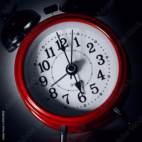 red alarm clock on dark background
