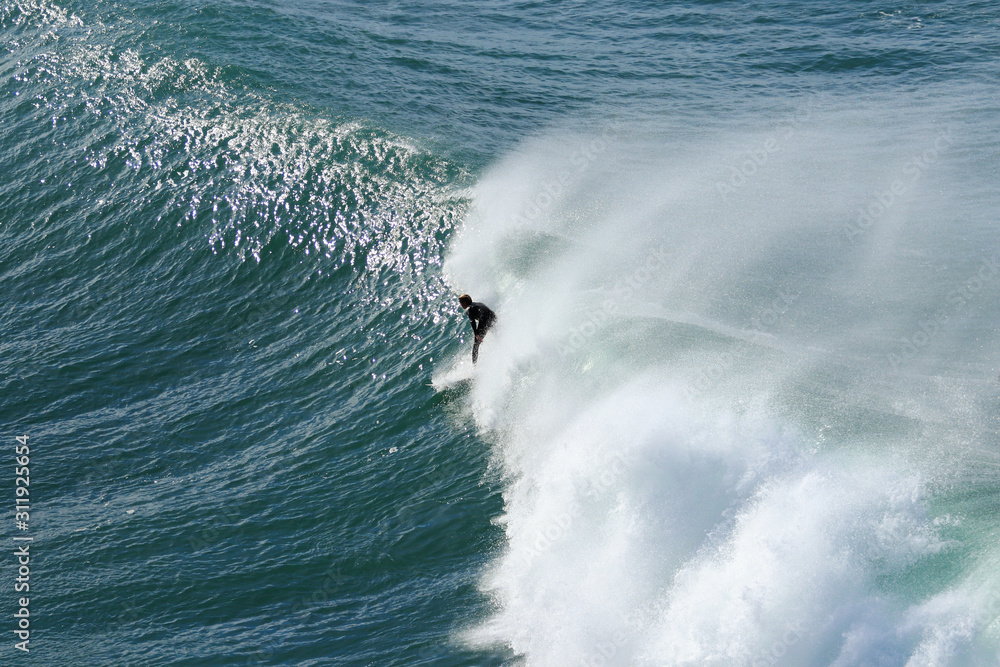 Surfer taking a big wave in Portugal Surfer taking a big wave in Portugal