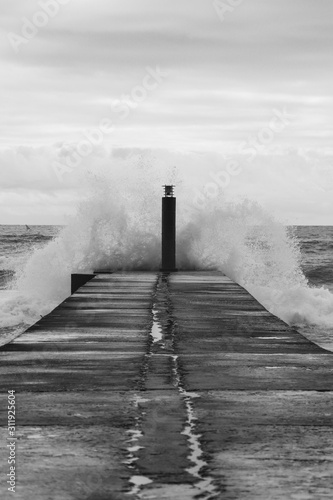 ig ocean wave hit in a jetty in a stormy day