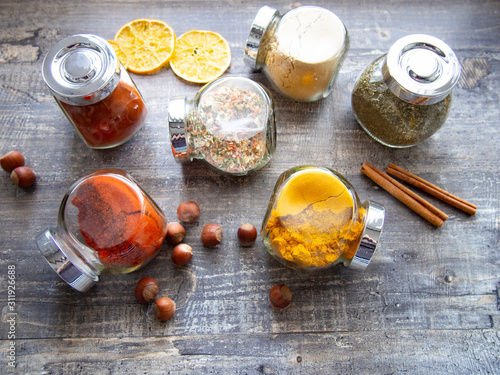 Bright aromatic spices in glass jars photo