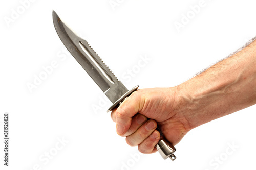 Hunting knife in a male hand isolated on a white background. Dagger in a man’s hand on a white background.