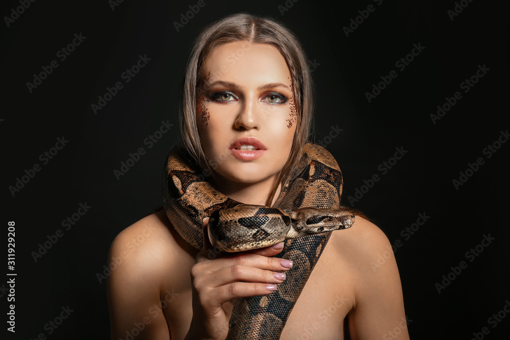 Beautiful woman with boa constrictor on black background Stock Photo ...
