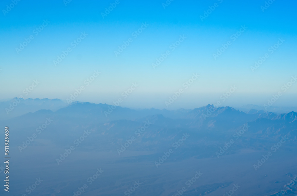City view in the clouds from an airplane, aerial view City view in the clouds from an airplane, aerial view