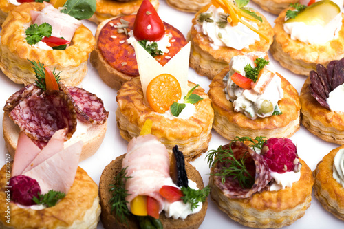 many different canapes on a white background