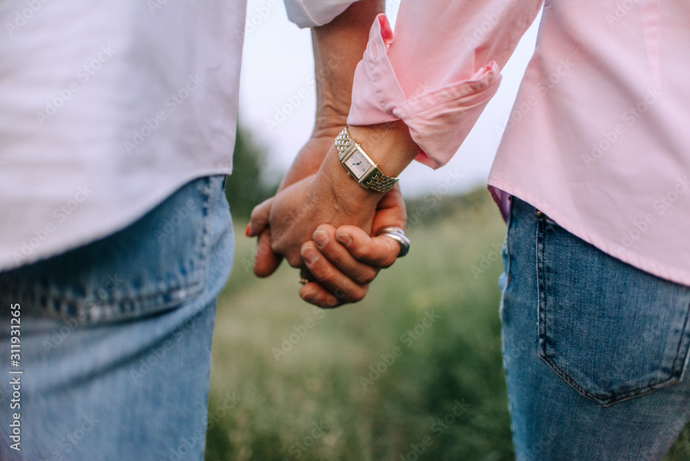 close up of middle age couple holding hands close up of middle age couple holding hands