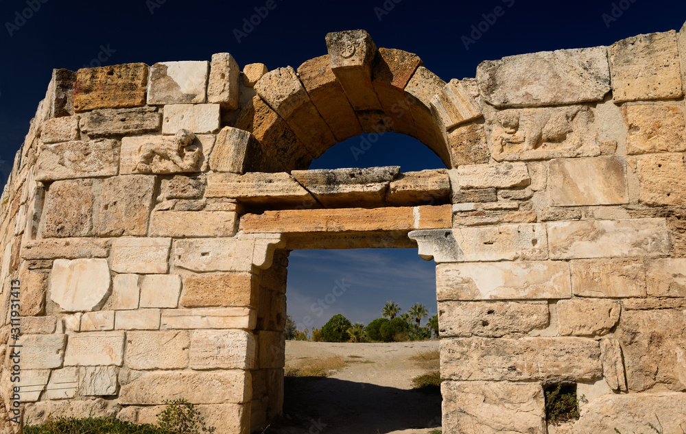 South west gate of Roman city wall with carved stone lion relief at Hierapolis Turkey
