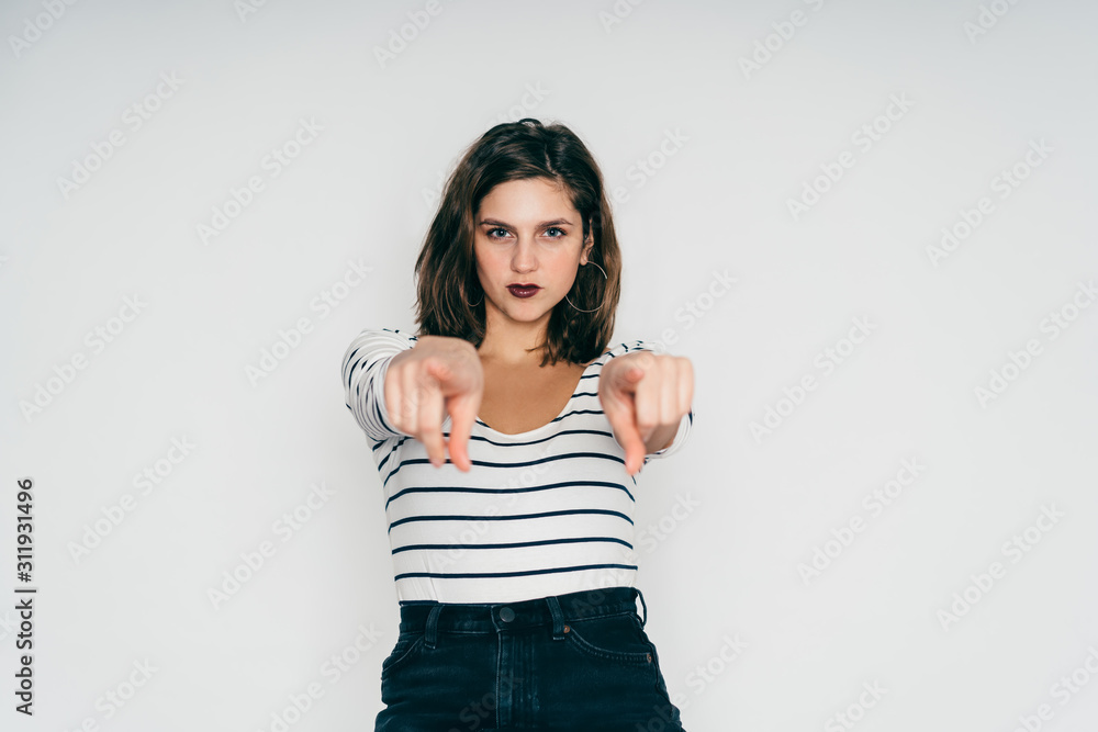 Woman pointing fingers at camera Woman pointing fingers at camera