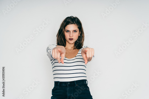 Woman pointing fingers at camera