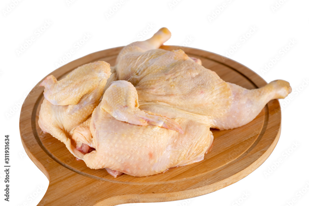 whole raw chicken on wooden cutting board isolated on white background