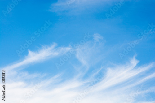 Cirrus clouds over a blue sky background