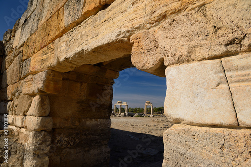 Ancient Roman columns with lintels seen through the stone block south gate at Hierapolis Turkey