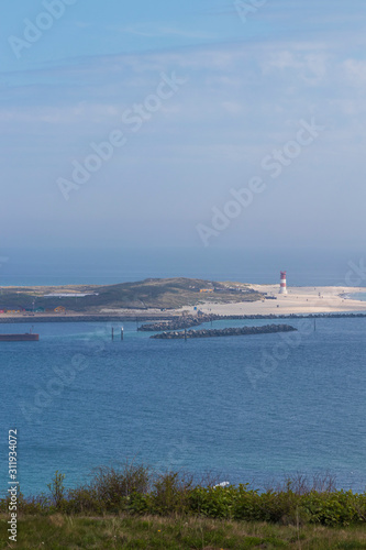 Houses and alleys on the island of Helgoland with a view of the landscape and the background of the island of Dune