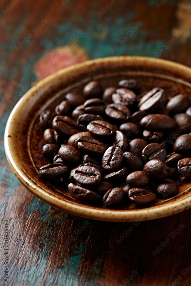 Fototapeta premium Coffee beans on rustic wooden background. Close up. 