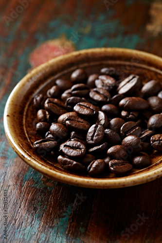 Coffee beans on rustic wooden background. Close up. 