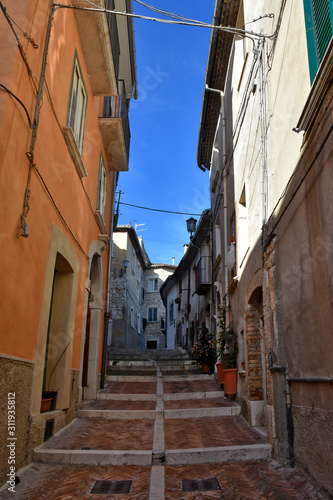 Fototapeta Naklejka Na Ścianę i Meble -  Campobasso, Italy, 24/12/2019. A narrow street between the old buildings of a medieval town